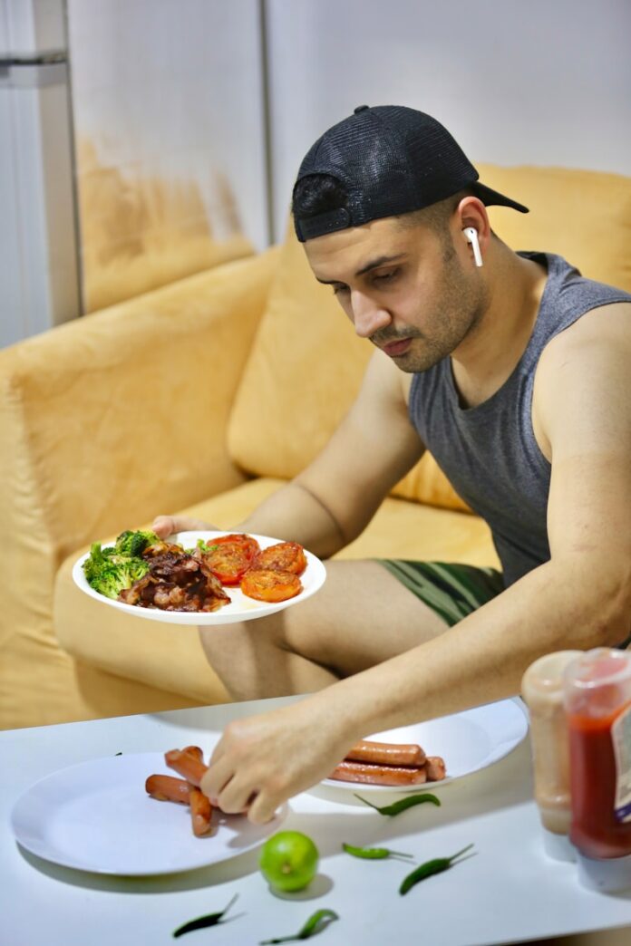 a man sitting at a table with a plate of food
