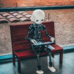 “AI와 함께하는 스마트 건강 관리…일상 속 실천법 제안” black and white robot toy on red wooden table