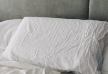 현대인의 숙면 트렌드, 실생활에서 실천하는 ‘슬기로운 수면 루틴’ A rumpled white duvet and pillows on a bed.