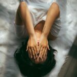 일상 속 스트레스, 새로운 관리법으로 한결 가볍게 a woman holds her hands over her face