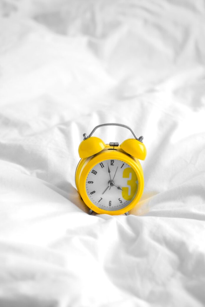 Photo by Laura Chouette white and gold analog alarm clock